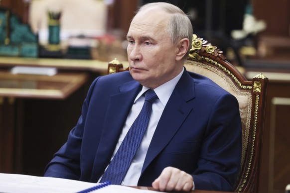 Russian President Vladimir Putin speaks with Yuri Chikhanchin, the Director of the Federal Financial Monitoring System, at the Kremlin in Moscow, Russia, Tuesday, July 8, 2025. (Mikhail Metzel, Sputni ...