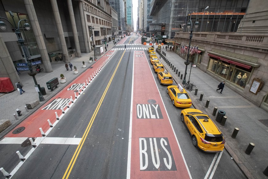 FILE - In this March 25, 2020, file photo, yellow cabs line an empty 42nd St. waiting for fares outside Grand Central Terminal, in New York. For the millions of Americans living under some form of loc ...