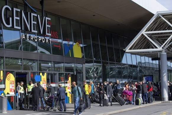 Security staff of the Geneve Aeroport check passengers who entry into the terminal of the airport as a precaution against the spread of the coronavirus COVID-19, in Geneve, Switzerland, Tuesday, March ...