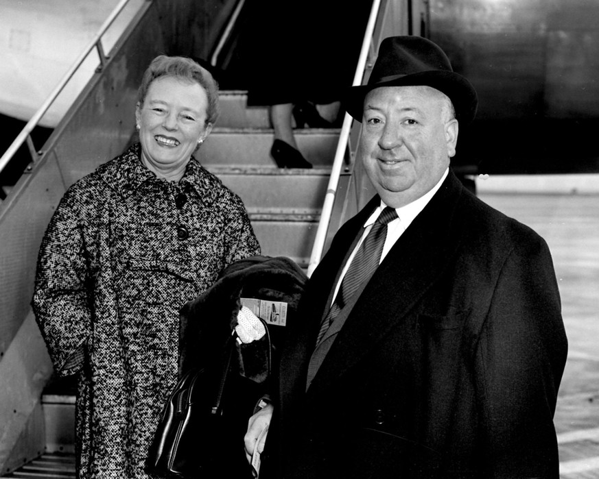 Hollywood film director Alfred Hitchcock and his wife are pictured as they boarded a Swissair plane for Zurich at London Airport. (Photo by PA Images via Getty Images)