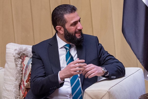 epa11869992 A handout photo made available by the Saudi Royal Palace shows Syrian interim President Ahmed al-Sharaa meeting with Saudi Crown Prince Mohammed bin Salman (not pictured) in Riyadh, Saudi  ...