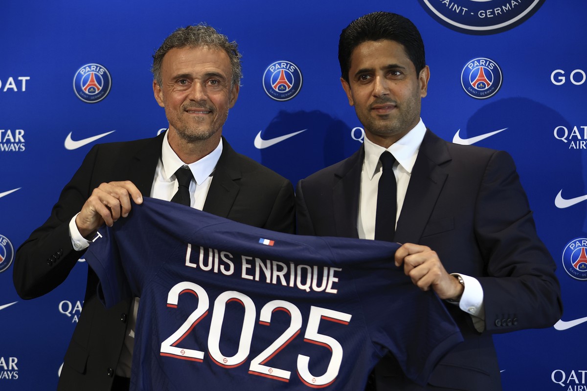Newly named PSG coach Luis Enrique, left, holds a team jersey with PSG president Nasser Al-Khelaifi during a press conference at the new Paris-Saint-Germain training ground Wednesday, July 5, 2023 in  ...