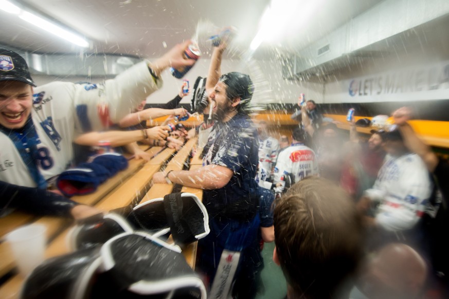 Zurich&#039;s players celebrate winning the Swiss championship title after the seventh match of the playoff final of the National League of the ice hockey Swiss Championship between the HC Lugano and  ...