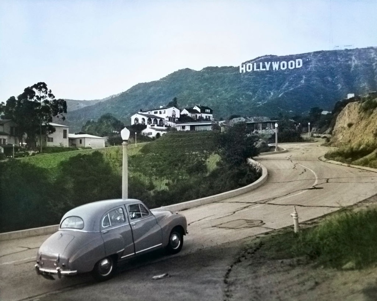 A 1950s Austin Car Driving Up a Road In The Hollywood Hills With the Hollywood Sign In the Distance Los Angeles California US. (Photo by Charles Phelps Cushing/Classicstock/Getty Images)