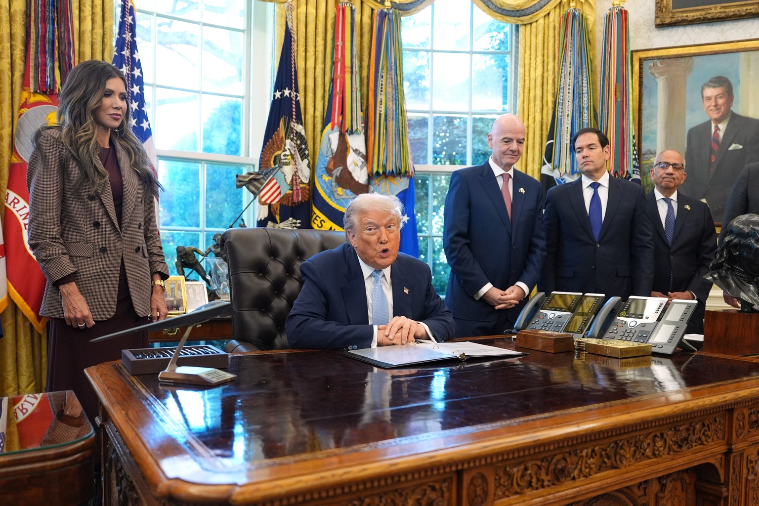 President Donald Trump answers questions from reporters during a meeting with the White House task force on the 2026 FIFA World Cup in the Oval Office of the White House, Monday, Nov. 17, 2025, in Was ...