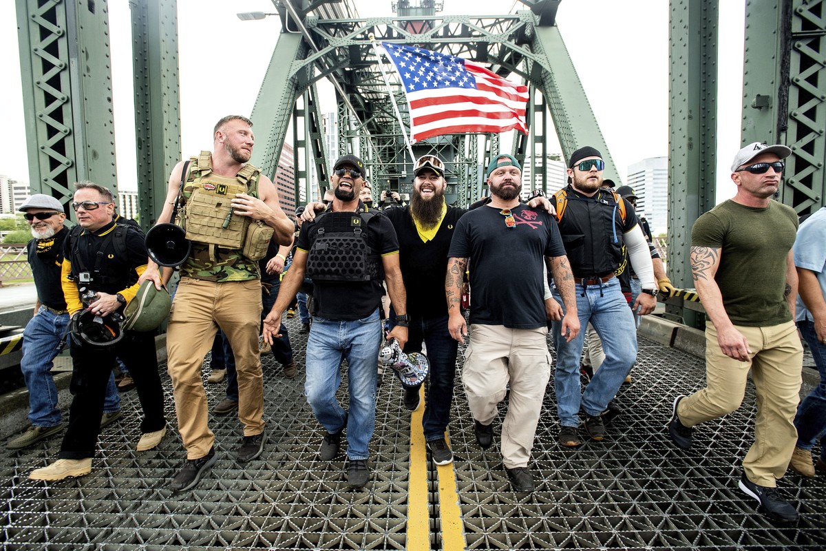 FILE - Members of the Proud Boys, including organizer Joe Biggs, third from right, march across the Hawthorne Bridge during an "End Domestic Terrorism" rally in Portland, Ore., on Saturday,  ...