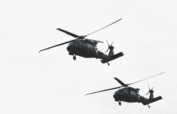 epa12547830 A US military Black Hawk helicopter (L) carries US Army Europe and Africa Commanding General Gen. Christopher Donahue (not pictured) for an aerial inspection of the US Army Garrison Black  ...