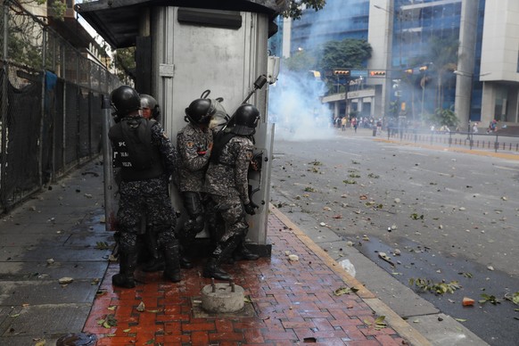 epa07313196 Bolivarian National Police officers take position as thousands take to the streets during a protest against President Maduro in Caracas, Venezuela, 23 January 2019. Juan Guaido, President  ...