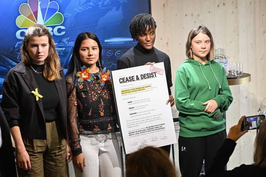 Climat activists Luise Neubauer of Germany, Helena Gualinga of Ecuador, Vanessa Nakate of Uganda and Greta Thunberg of Sweden, from left, take a pose with a 'Cease and Desist' Letter to Fuel ...
