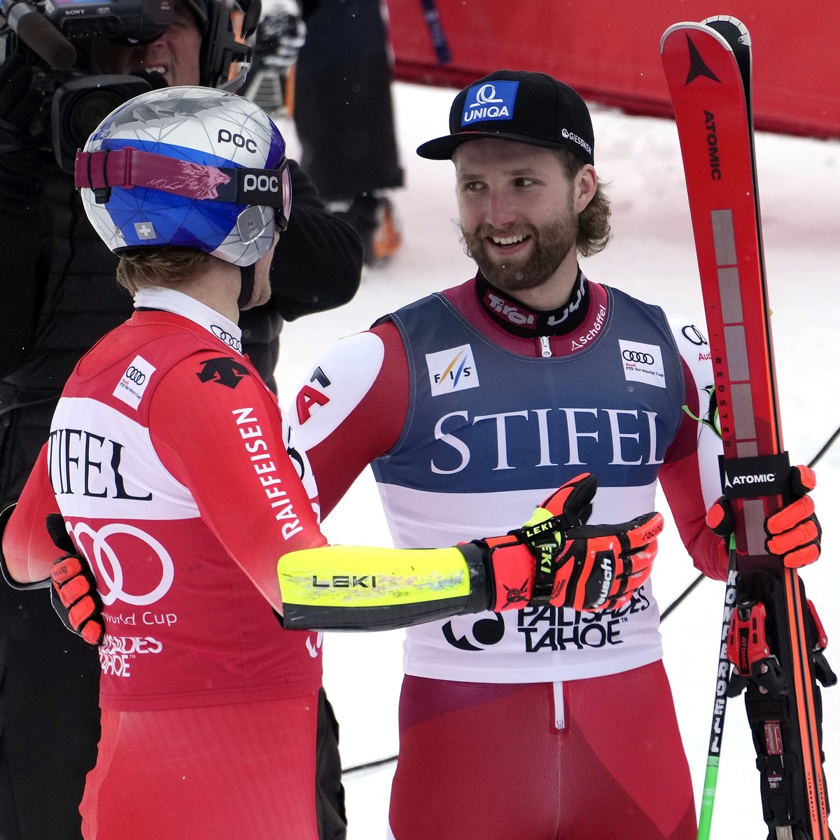 Switzerland's Marco Odermatt, left, and Austria's Marco Schwarz congratulate each other after Schwarz won the men's World Cup giant slalom skiing race and Odermatt took second Saturday, ...