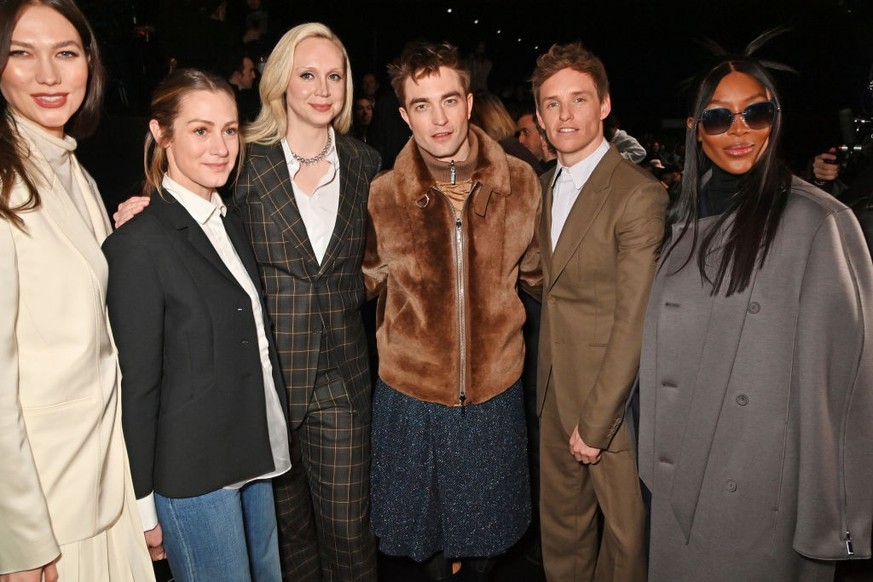 PARIS, FRANCE - JANUARY 20: (L to R) Karlie Kloss, Hannah Redmayne, Gwendoline Christie, Robert Pattinson, Eddie Redmayne and Naomi Campbell attend the Dior Homme front row during Paris Fashion Week M ...