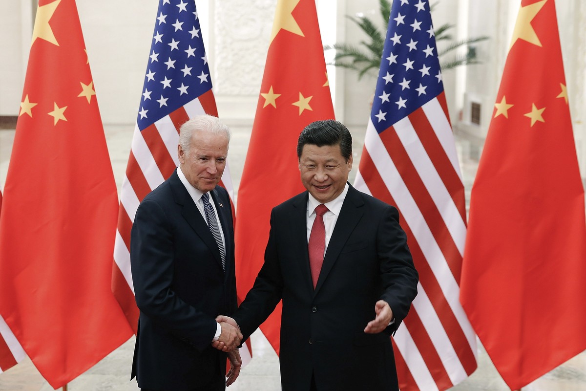 FILE - In this Dec. 4, 2013, file photo, Chinese President Xi Jinping, right, shakes hands with then U.S. Vice President Joe Biden as they pose for photos at the Great Hall of the People in Beijing. A ...