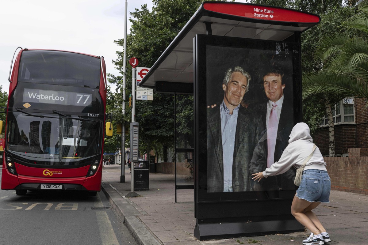 Activists put up a poster showing President Donald Trump and Jeffrey Epstein near the U.S. Embassy in London, Thursday, July 17, 2025.(AP Photo/Thomas Krych)
Britain Trump Epstein