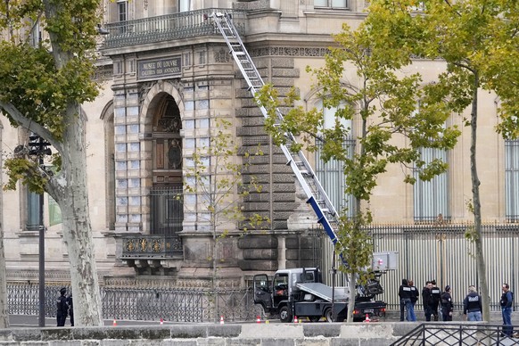 Police officers work by a basket lift used by thieves Sunday, Oct. 19, 2025 at the Louvre museum in Paris. (AP Photo/Thibault Camus)
France Louvre