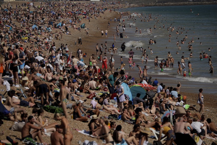 On Britain's hottest day of the year so far with temperatures reaching 32.6 degrees at Heathrow, people relax on Brighton Beach in Brighton, England, Wednesday, June 24, 2020. The British governm ...