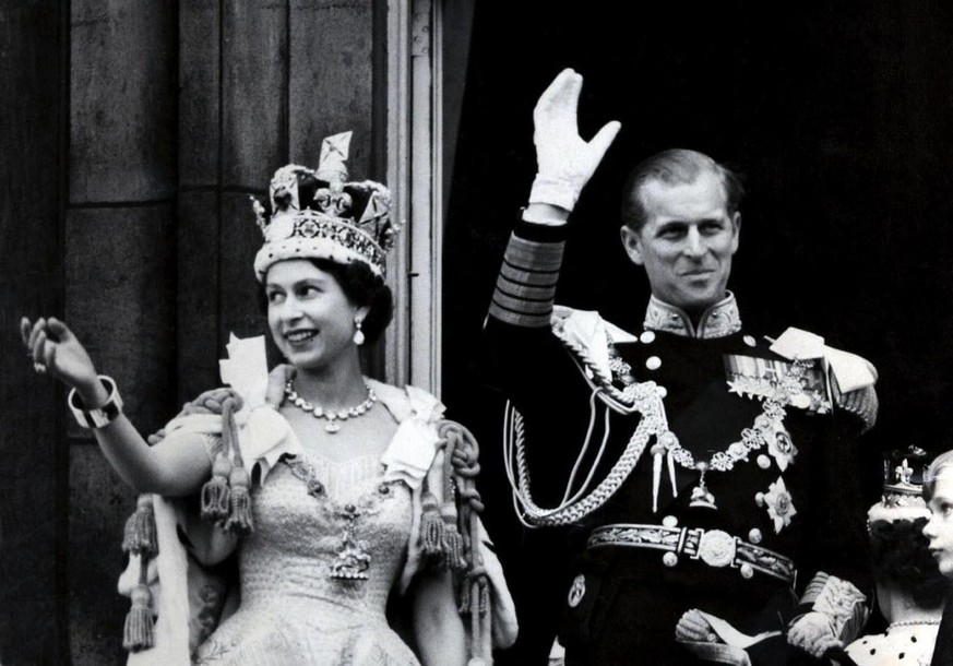 Picture dated 02 June 1953 of Britain&#039;s Queen Elizabeth II wearing the Imperial State Crown as she and her husband, the Duke of Edinburgh - dressed in the uniform of Admiral of the Fleet - wave f ...