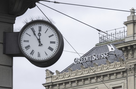 FILE - A clock next to a logo of the Swiss bank Credit Suisse, in Zurich, Switzerland, on March 20, 2023. Once-venerable Credit Suisse is heading into a possible firestorm Tuesday April 4, 2023 as sha ...