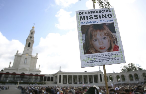 FILE - A picture of missing British girl Madeleine McCann, who disapeared from the Praia da Luz beach resort in the Algarve, is displayed at Our Lady of Fatima shrine Sunday, May 13 2007, in Fatima, n ...