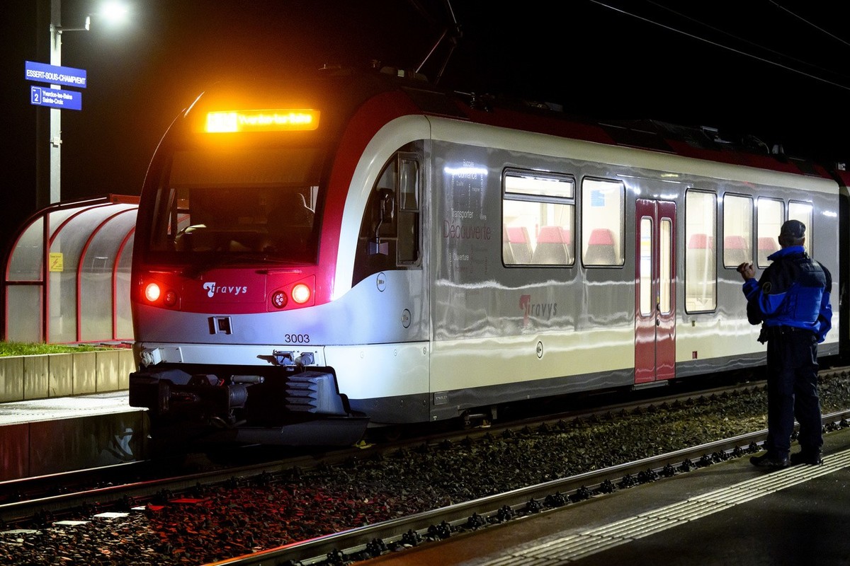 Vaud cantonal police officer watchs the Travys train where a hostage-taking incident took place at Essert-sous-Champvent station, Switzerland, Thursday, 8, February, 2024. A hostage-taking incident to ...