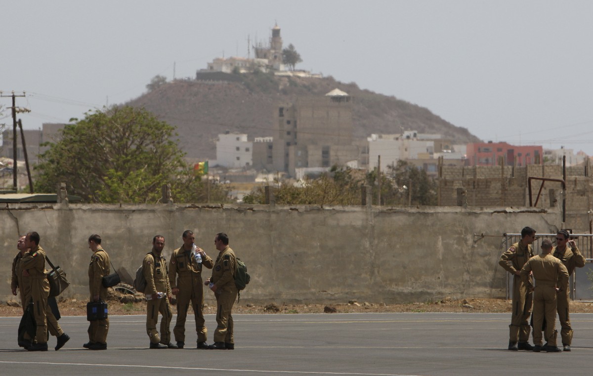 FILE - Members of a French military flight crew talk on the tarmac at France's military air base in Dakar, Senegal, between flights toward the presumed site of the crash of a missing Air France f ...