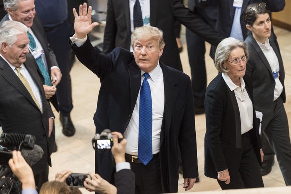 Donald Trump, President of the United States of America, center, arrives at the Congress Center next to Hilde Schwab. Chairperson and WEF Co-Founder, right, adresses a plenary session during the 48th  ...