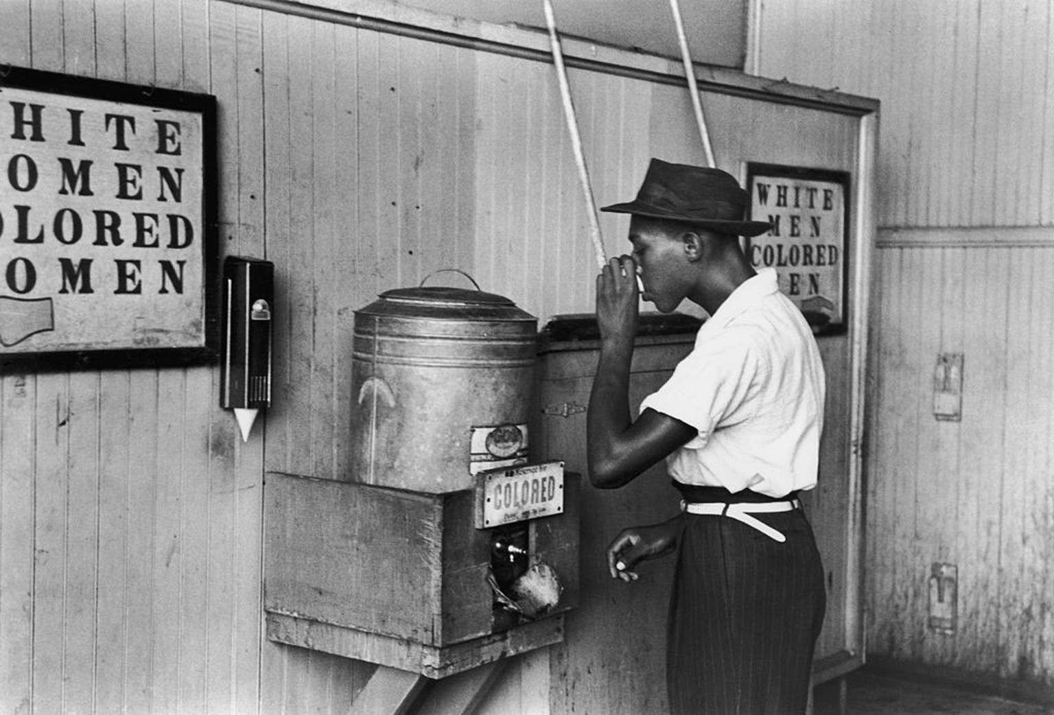 July 1939: An African-American man drinking at a segregated drinking fountain in Oklahoma City, Oklahoma. (Photo by Russell Lee/Library Of Congress/Getty Images)