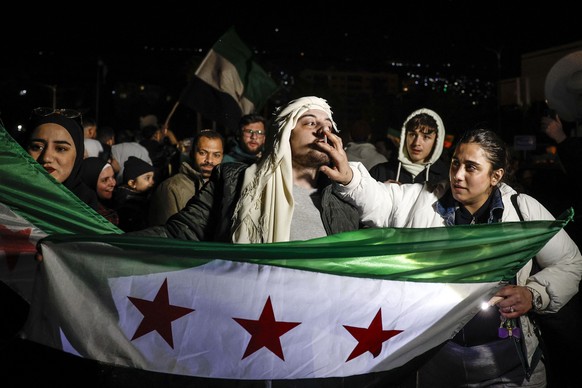 epa11775598 People celebrate days after the overthrow of President Bashar al-Assad by opposition rebels, in Damascus, Syria, 13 December 2024. Hay&#039;at Tahrir Al-Sham (HTS) leader Abu Mohammad Al-J ...
