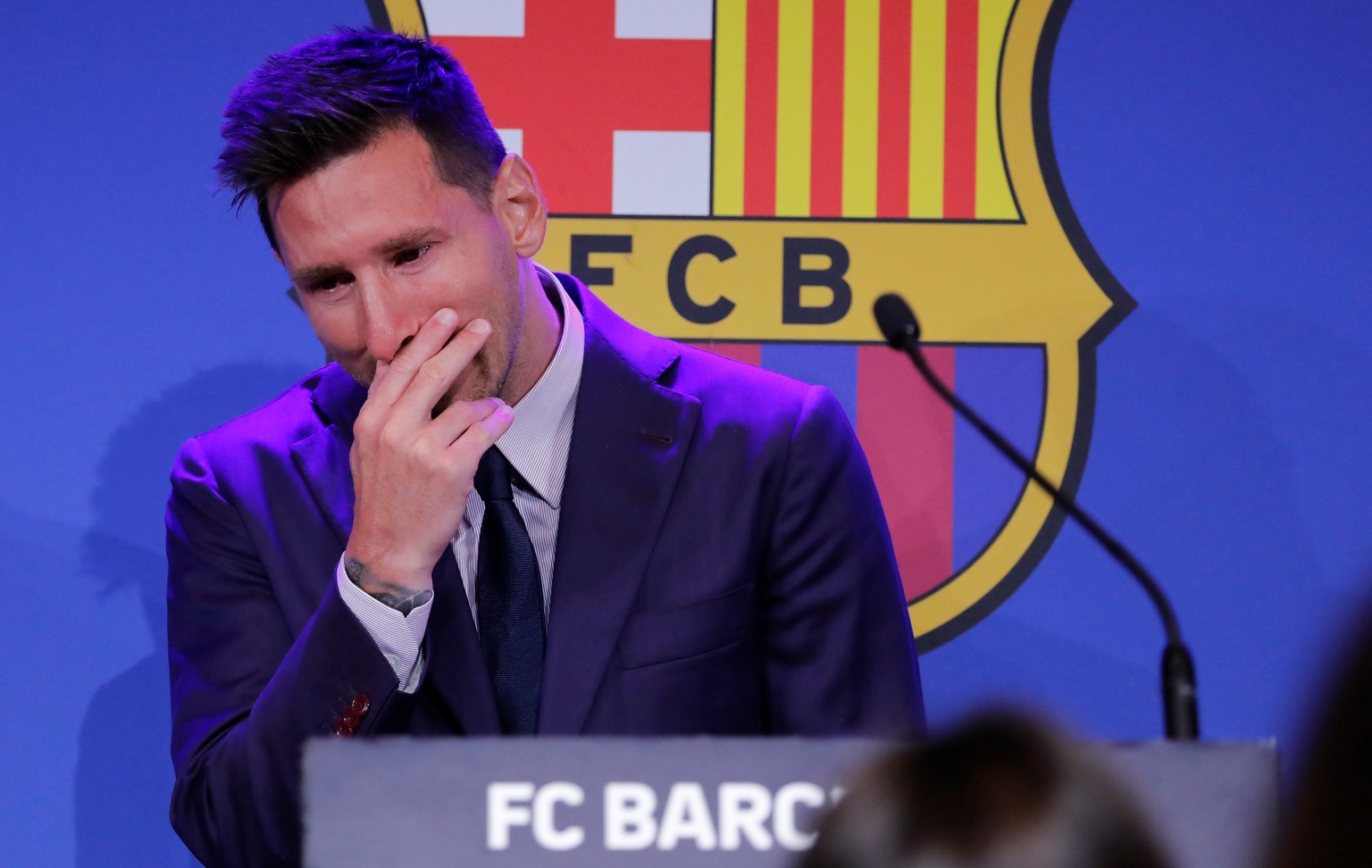 epa09405789 Argentine forward Lionel Messi gets emotional during a press conference to explain his version of the reasons for his departure from Barcelona FC in Barcelona, Spain, 08 August 2021. FC Ba ...