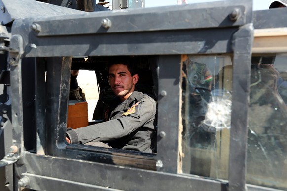 epa05590525 A Member of Iraqi special forces looks through the window of an armored vehicle during a military operation to liberate several villages from the control of the so-called Islamic State (IS ...