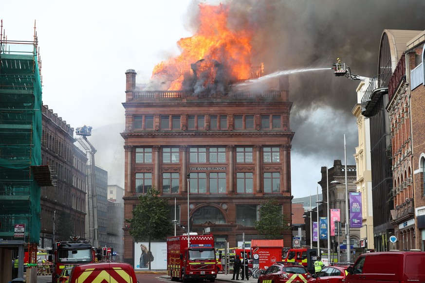 A firefighter trains a hose on a major blaze which has broken out at the Primark store in Belfast city centre, in Northern Ireland, Tuesday Aug. 28, 2018. The Northern Ireland Fire and Rescue Service  ...