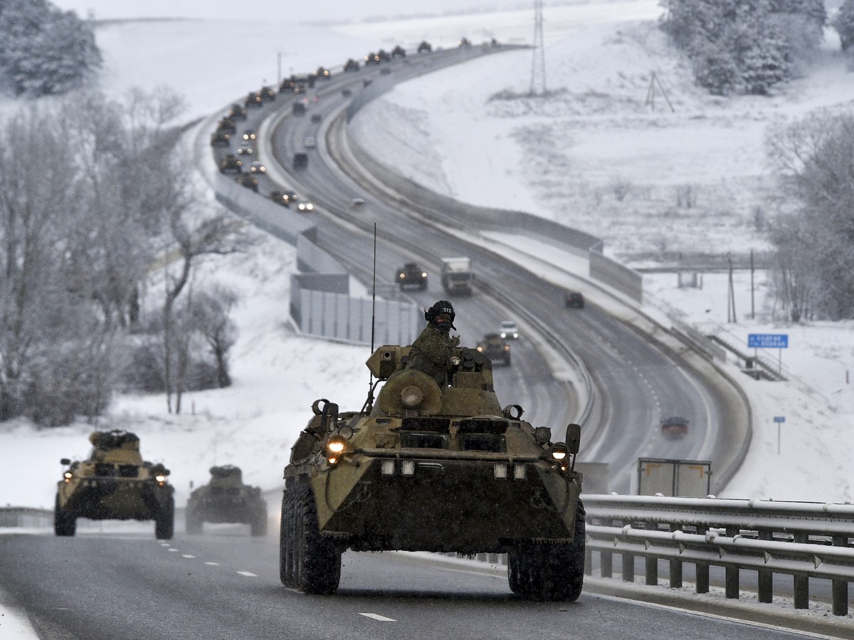 FILE - A convoy of Russian armored vehicles moves along a highway in Crimea, Jan. 18, 2022. Russia has concentrated an estimated 100,000 troops with tanks and other heavy weapons near Ukraine in what  ...