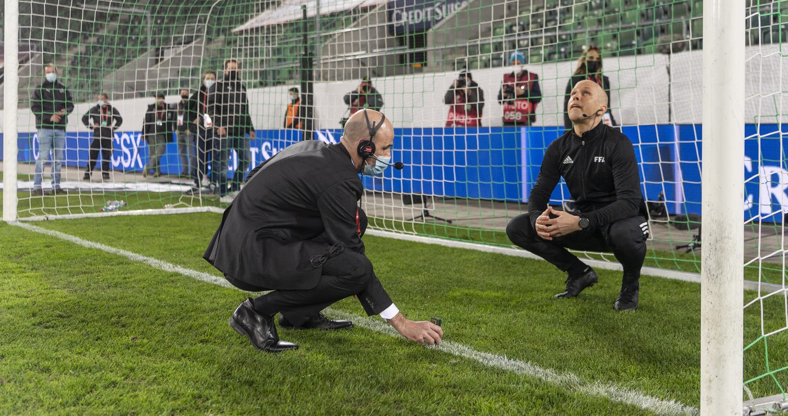 epa09103624 Officials measure the replacement goal after the original one was found to be deficient ahead of the FIFA World Cup Qatar 2022 qualifying Group C soccer match between Switzerland and Lithu ...