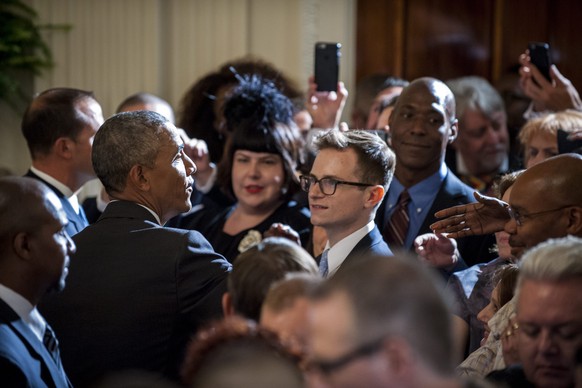epa05354029 US President Barack Obama greets people in the crowd after delivering remarks at a reception in the East Room of the White House in recognition of LGBT Pride Month in Washington, DC, USA,  ...