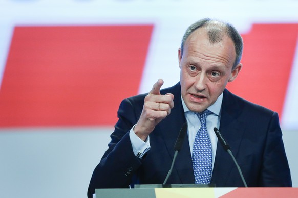 Party member Friedrich Merz addresses the delegates during a Christian Democratic Union party convention in Leipzig, Germany, Friday, Nov. 22, 2019. (AP Photo/Jens Meyer)