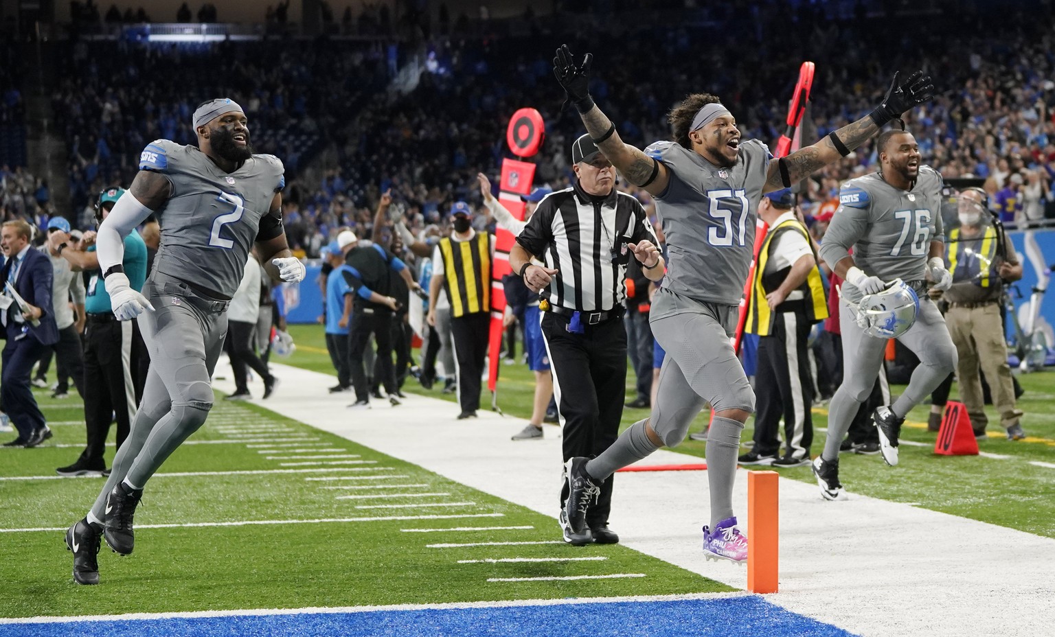 Detroit Lions linebacker Josh Woods (51) and linebacker Austin Bryant (2) run off the field after the second half of an NFL football game against the Minnesota Vikings, Sunday, Dec. 5, 2021, in Detroi ...
