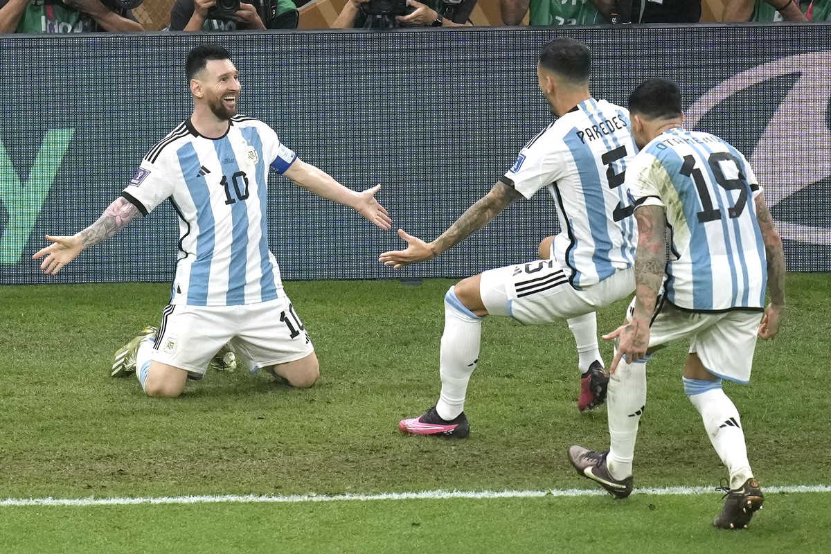 Argentina's Lionel Messi, left, celebrates his side's third goal during the World Cup final soccer match between Argentina and France at the Lusail Stadium in Lusail, Qatar, Sunday, Dec. 18, ...