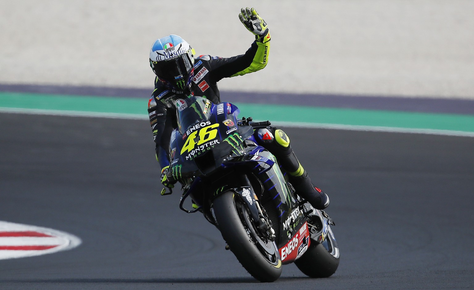 Yamaha rider Valentino Rossi, of Italy, waves his fans at the end of the qualifying session for Sunday&#039;s Emilia Romagna Motorcycle Grand Prix at the Misano circuit in Misano Adriatico, Italy, Sat ...