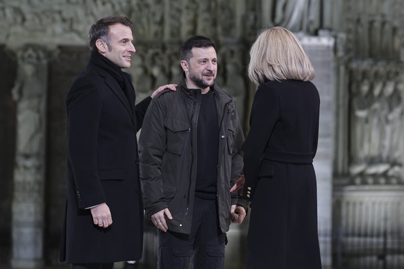 French President Emmanuel Macron and his wife Brigitte greet Ukrainian President Volodymyr Zelenskyy outside France&#039;s iconic Notre Dame Cathedral Saturday, Dec. 7, 2024 in Paris for it&#039;s for ...