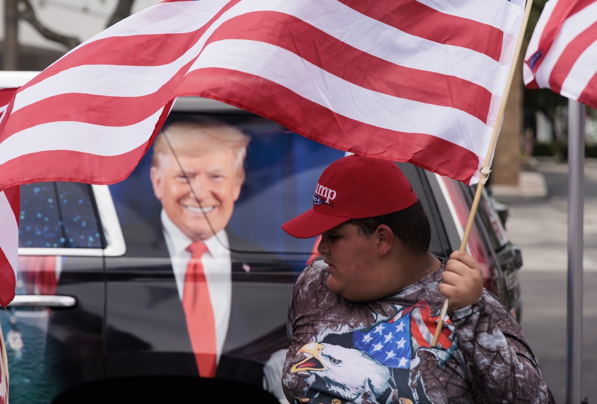 epa10687482 Supporters of former President Donald Trump gather near the entrance to the Trump National Doral Miami golf course for a rally to show support for Trump in Doral, Florida, USA, 12 June 202 ...