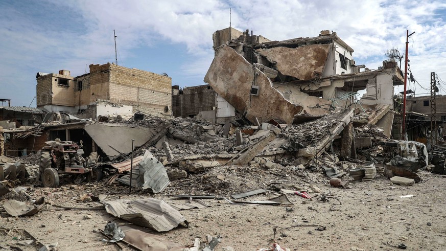 epa06547069 A general view of a destroyed building from an alleged barrel bomb attack, at rebels-held Douma, Syria, 20 February 2018. At least seven people were killed on the same day in Douma, as all ...