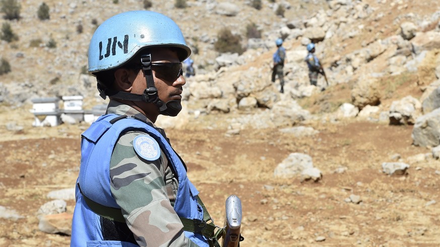 epa10161118 Soldiers of the UN peacekeeping mission, United Nations Interim Force In Lebanon (UNIFIL) keep watch at the Blue Line, the line of withdrawal between Lebanon and Israel, during a visit org ...