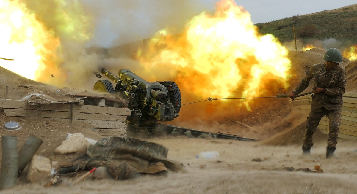 In this Sunday, Oct. 4, 2020 photo, an Armenian soldier fires an artillery piece during fighting with Azerbaijan's forces in self-proclaimed Republic of Nagorno-Karabakh, Azerbaijan. Heavy fighti ...