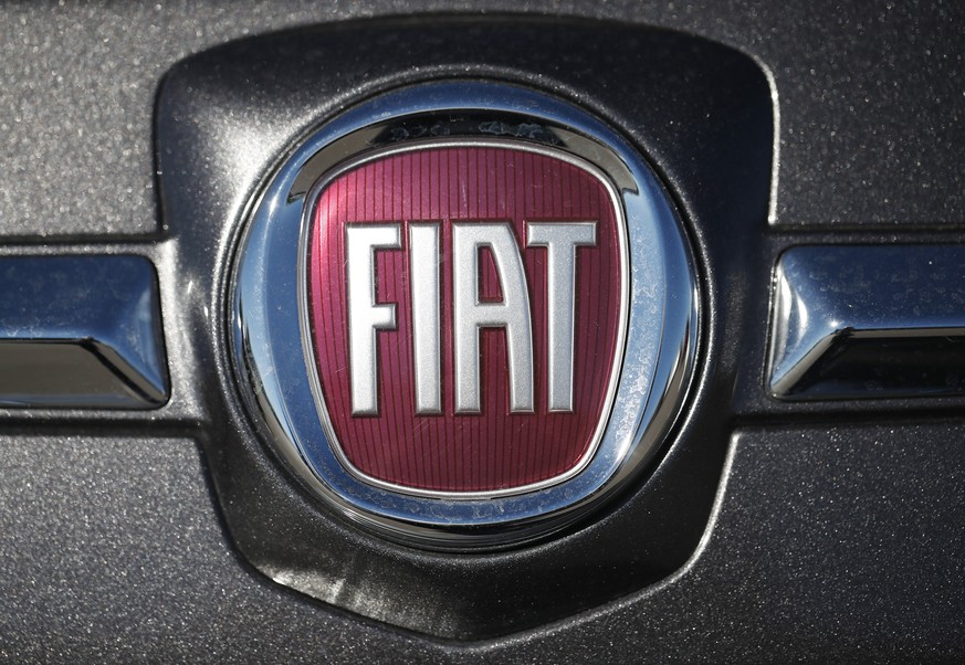 FILE- In this Oc. 21, 2018, file photo the company logo shines off the front of a vehicle at a Fiat dealership in Highlands Ranch, Colo. Fiat Chrysler is voluntarily recalling vehicles in the U.S. bec ...