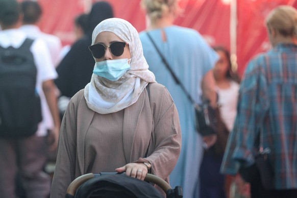 17.07.2024. Russia. Moscow. A Muslim woman in a hijab and a medical mask in the summer on a Moscow street. Alexey Belkin/NEWS.ru BelkinxAlexey