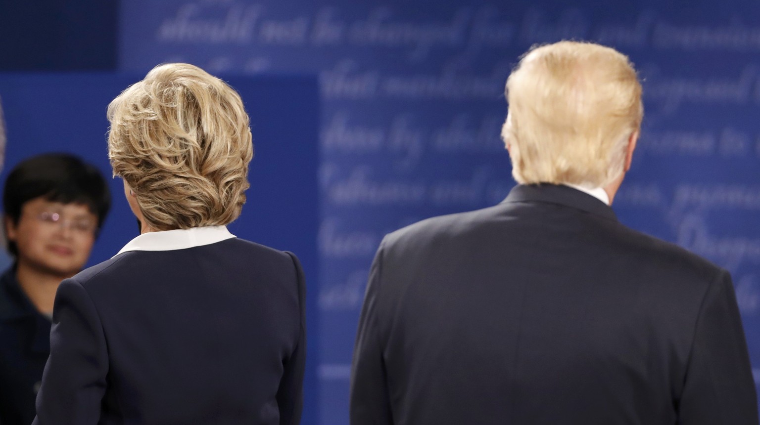 Republican U.S. presidential nominee Donald Trump and Democratic U.S. presidential nominee Hillary Clinton face the audience during their presidential town hall debate at Washington University in St.  ...