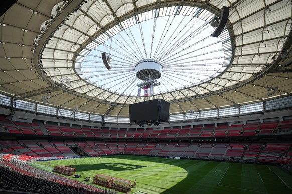 FILE - Stadium staff prepare temporary grass that was laid on top of artificial turf at BC Place stadium for a friendly soccer match between MLS soccer's Vancouver Whitecaps and League One's ...