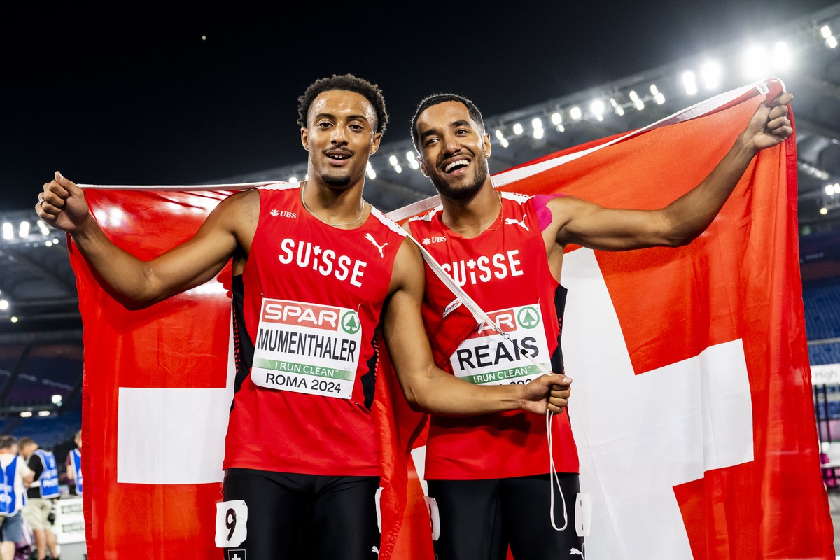 Gold medalist Timothe Mumenthaler of Switzerland, left, and bronze medalist William Reais of Switzerland, right, celebrate during the men's 200 meters final at the European Athletics Championship ...