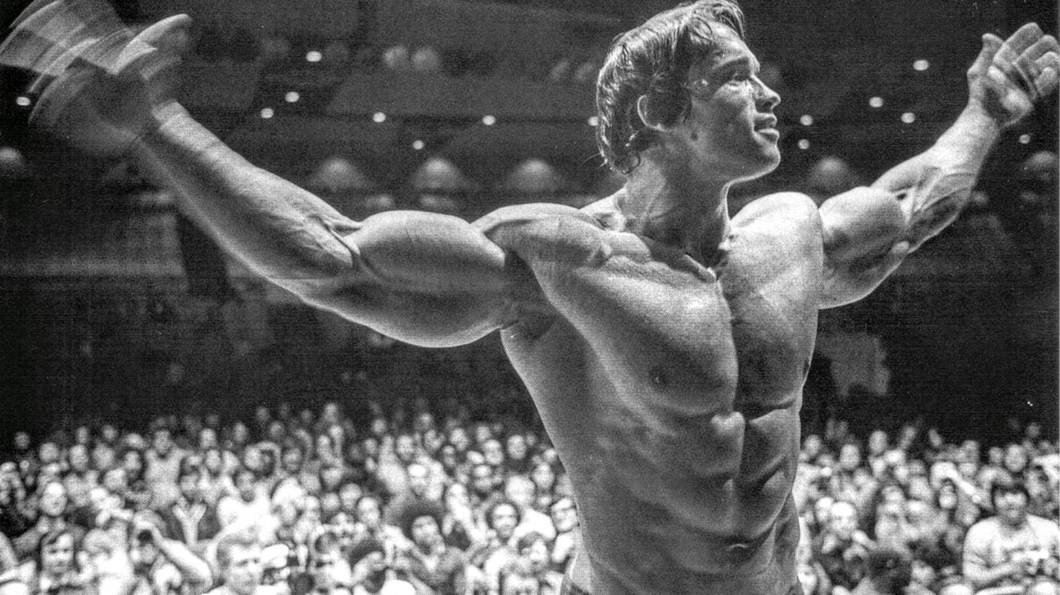 Arnold Schwarzenegger posing in the Mr. Olympia competition (1974)