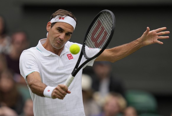 Switzerland&#039;s Roger Federer returns the ball to Italy&#039;s Lorenzo Sonego on day seven of the Wimbledon Tennis Championships in London, Monday, July 5, 2021. (AP Photo/Kirsty Wigglesworth)