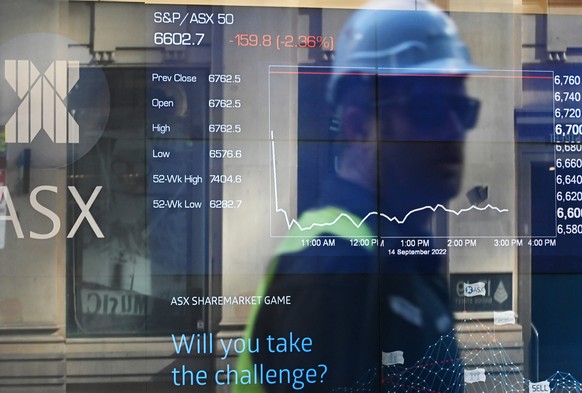 epa10182904 Indicator boards are seen as people are reflected in the window of the Australian Securities Exchange (ASX) in Sydney, Australia, 14 September 2022. The Australian stock market is on pace  ...